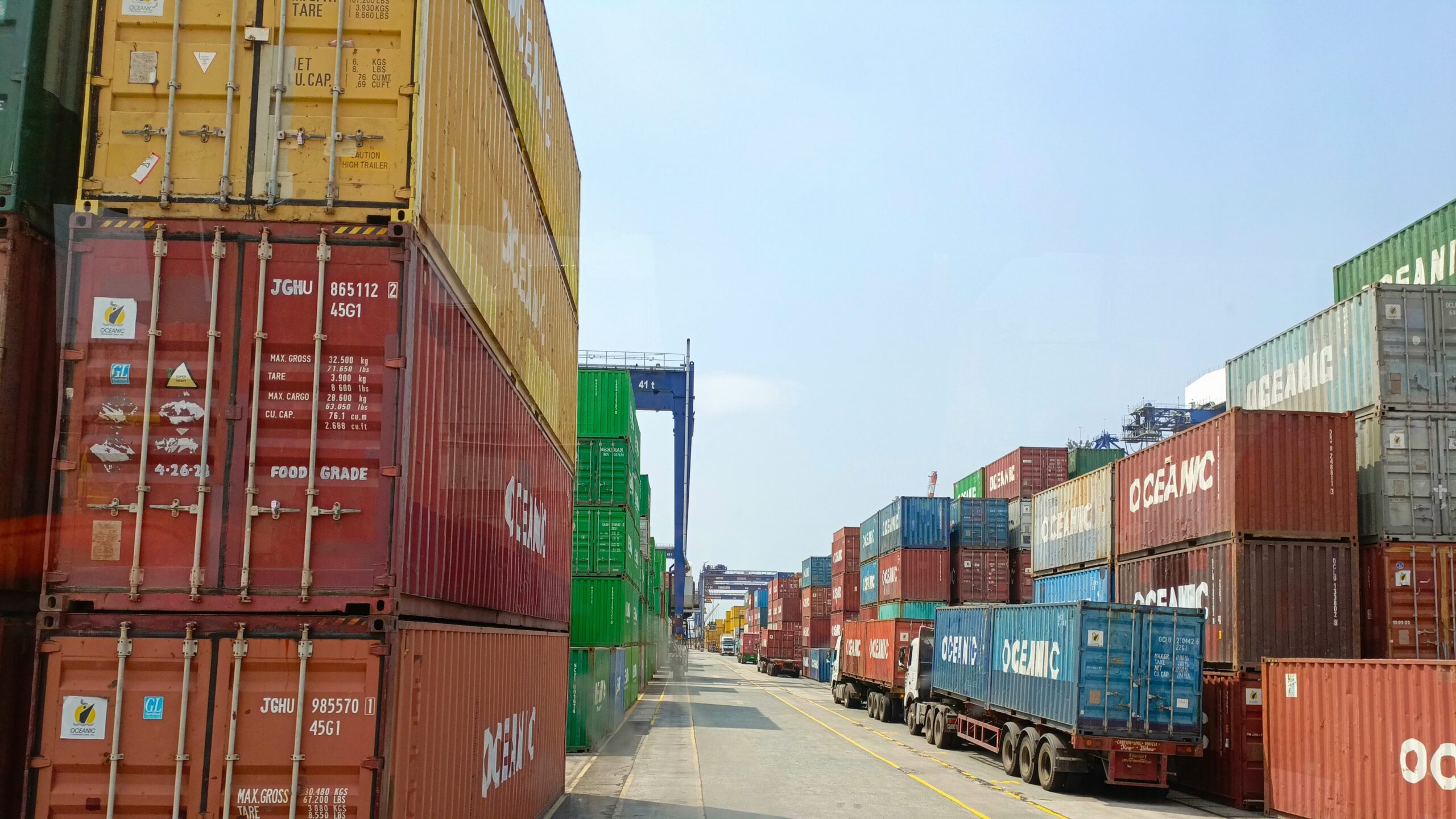 a long line of shipping containers on the side of a road