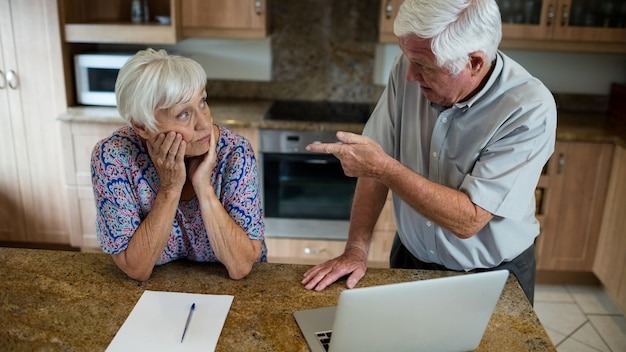 Senior couple arguing in kitchen at home
