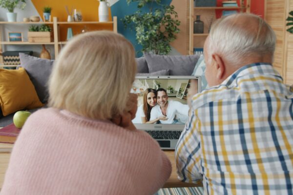 Elderly couple video calling with family at home.