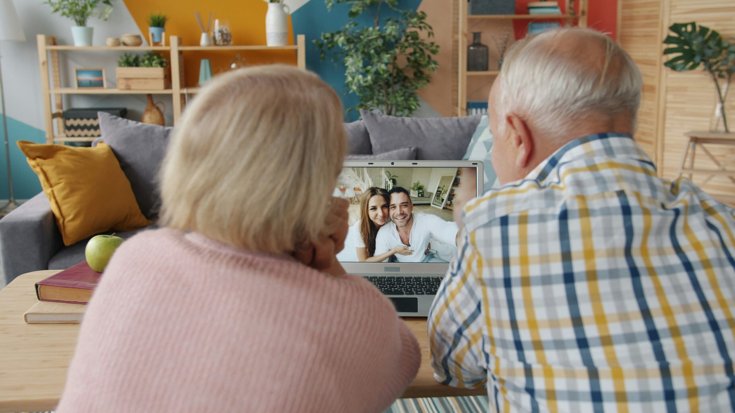 Elderly couple video calling with family at home.