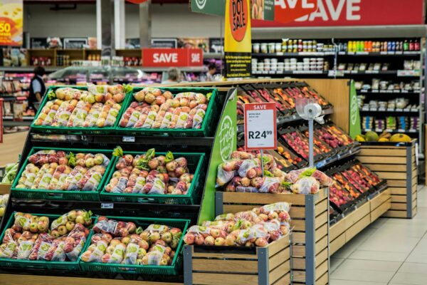 Apples and other produce are displayed in a supermarket.