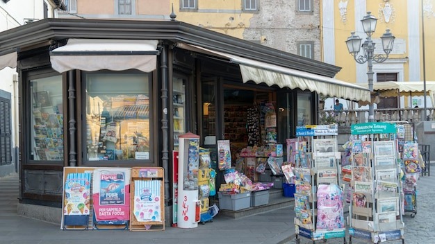 Newsagents shop exterior newsstands full of foreign daily newspapers