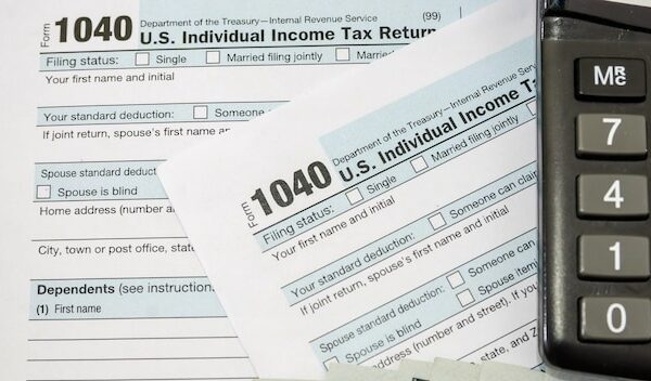 Tax forms with dollars and calculator