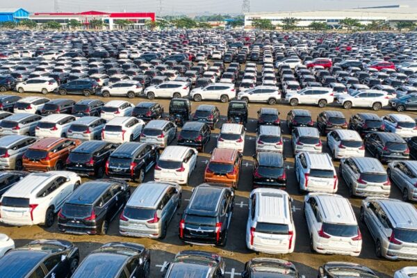 From above of rows with many modern new shiny automobiles of contemporary industry in daytime