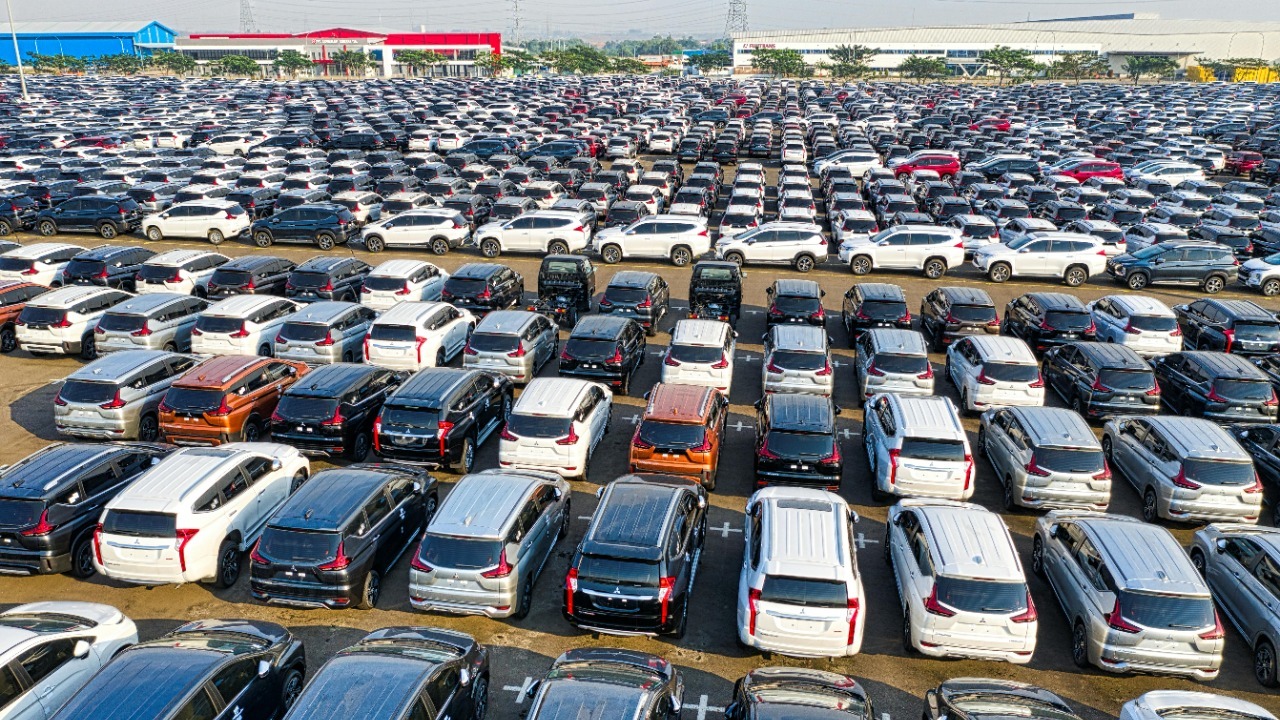 From above of rows with many modern new shiny automobiles of contemporary industry in daytime