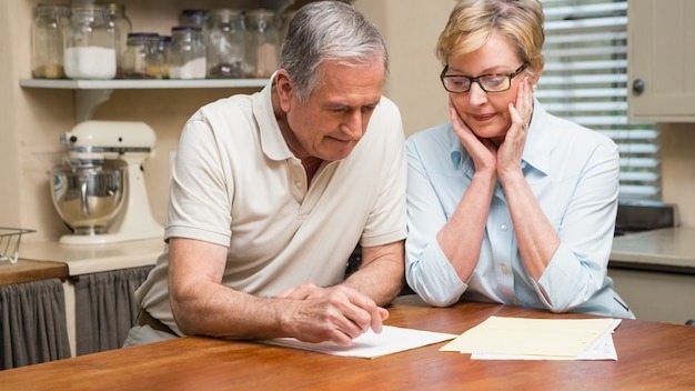 Senior couple working out their bills