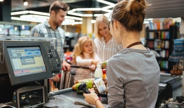 Beautiful family standing at the cash counter