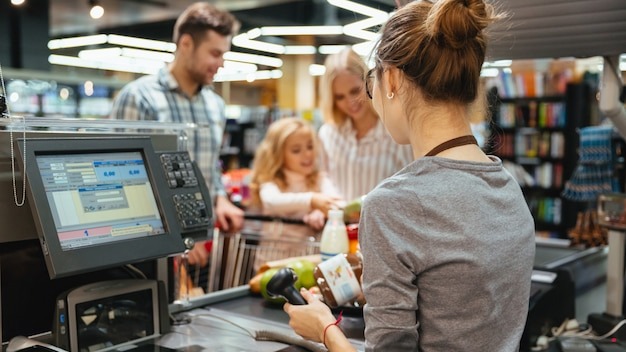 Beautiful family standing at the cash counter