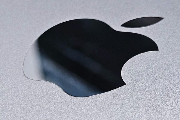 a close up of an apple logo on a silver surface