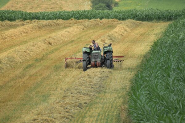 a couple of people on a tractor in a field