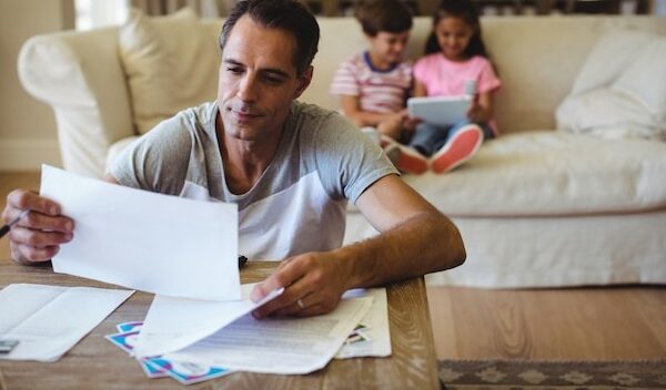 Man holding a bill in living room